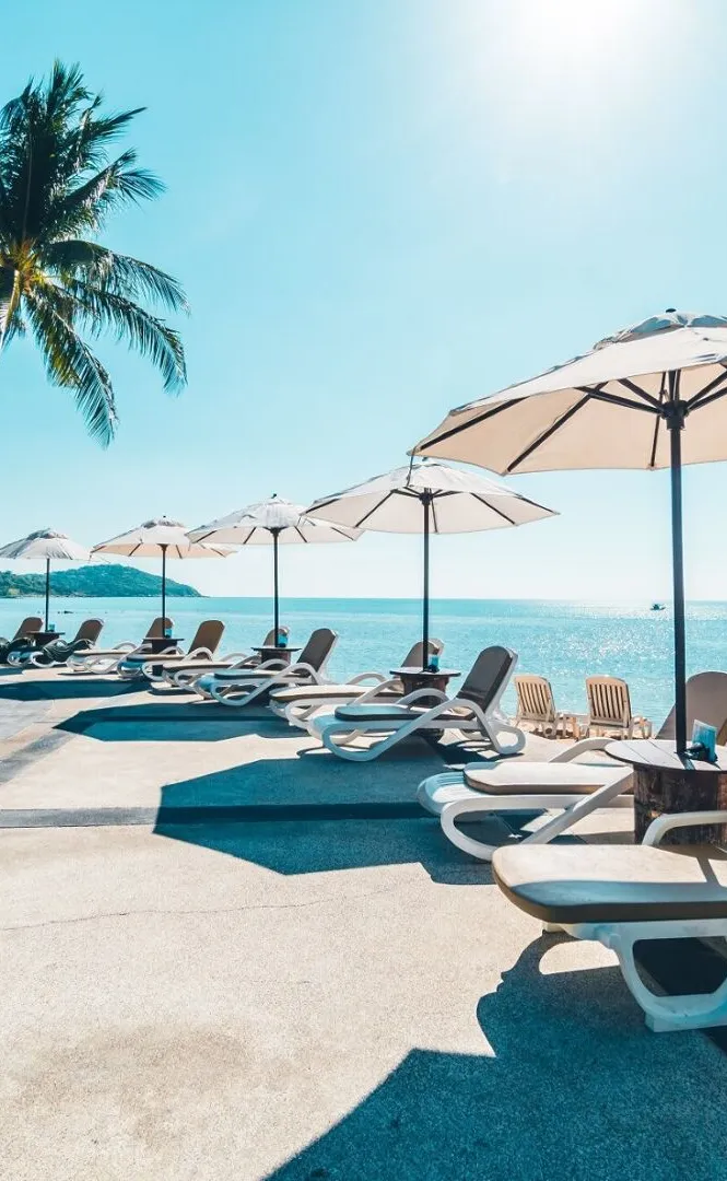 A quiet beach with a parasol looking out to a calm sea