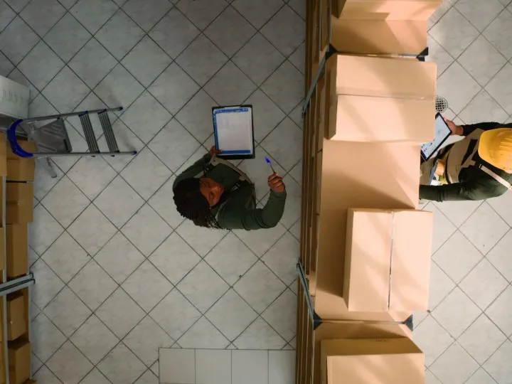 Warehouse coworkers examine parcels