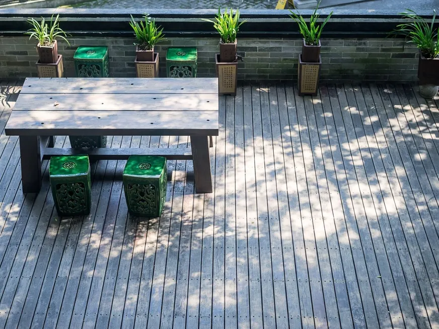 Terrace with a wooden table and plants
