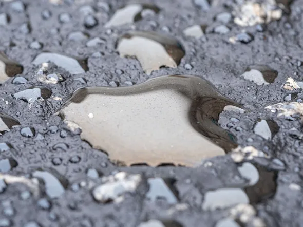 Detailed view of wet asphalt surface showing