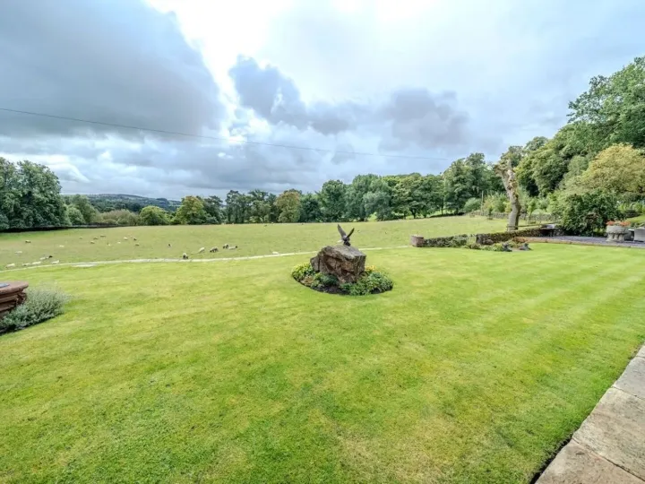 The lawn and sheep fields at Mellor Knowl Farm under a big sky