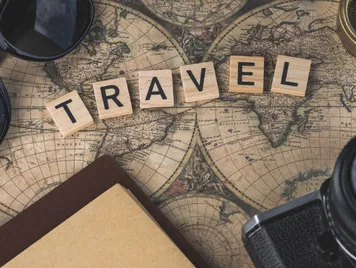 Vintage map with travel essentials like camera