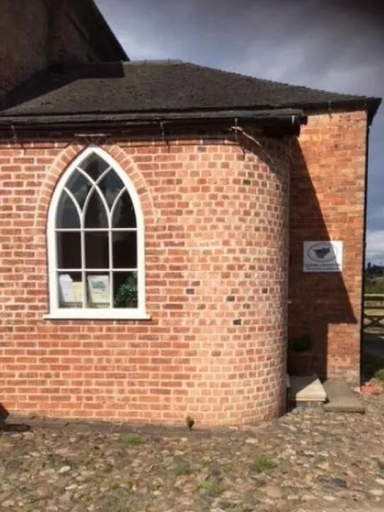 The ChALC county office, a red-brick building with an arched window