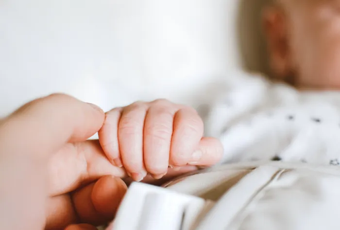 person-holding-baby-s-hand-2721581