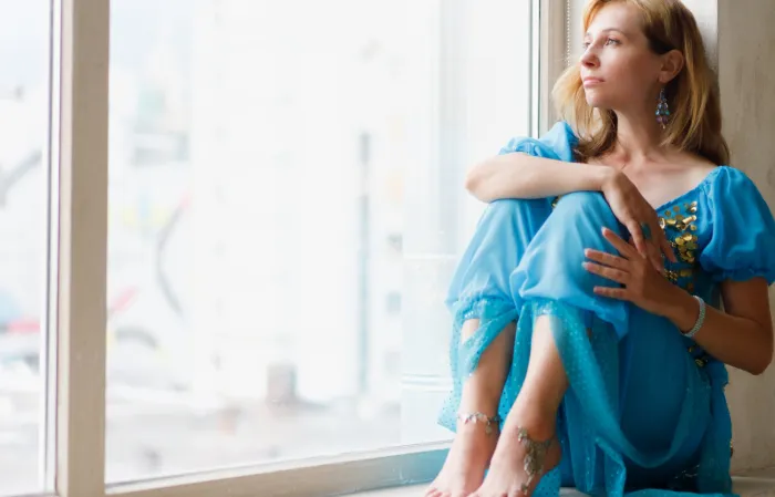 Woman sitting in a window