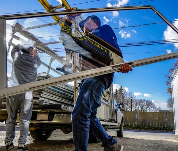 Workers unloading aluminium window
