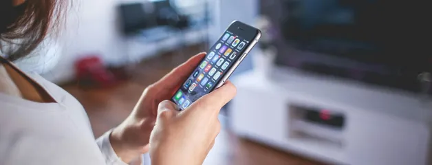 Woman browsing smartphone indoors, highlighting