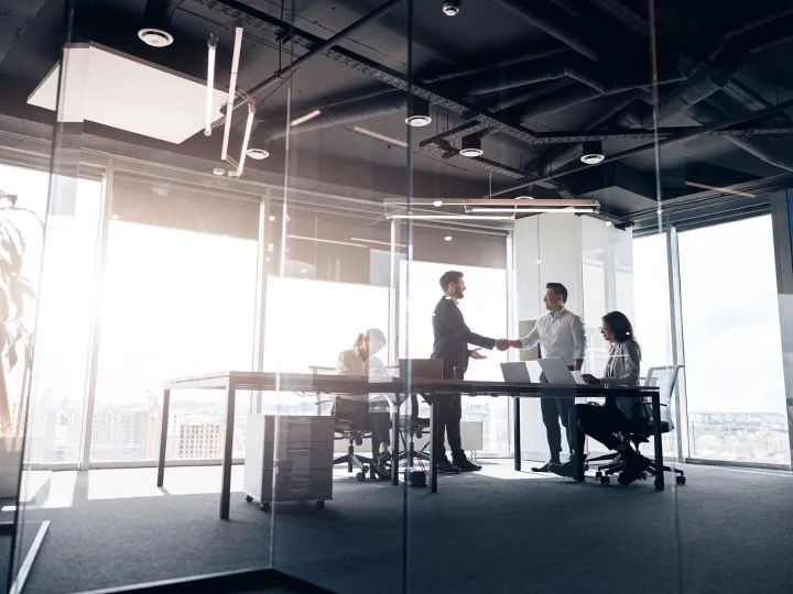 People standing near table team of young businessmen working