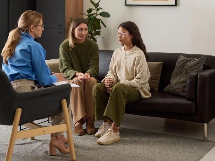 Teenage girl sharing mental health problems with therapist