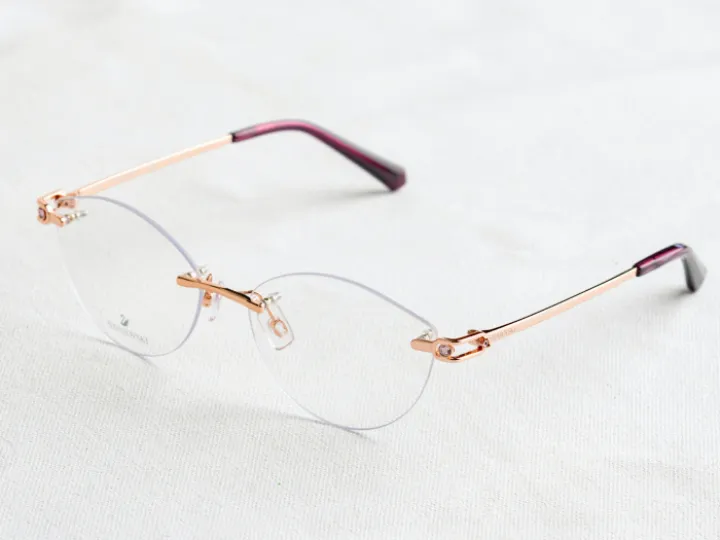 Rimless glasses on white fabric