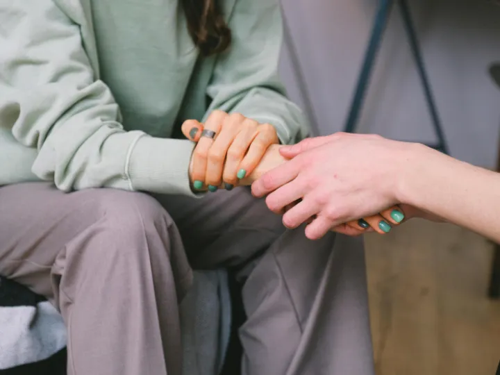 Crop psychologist supporting patient during counseling indoors