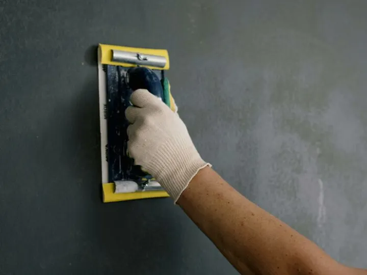 Crop Man Scarpering Gray Wall in Flat