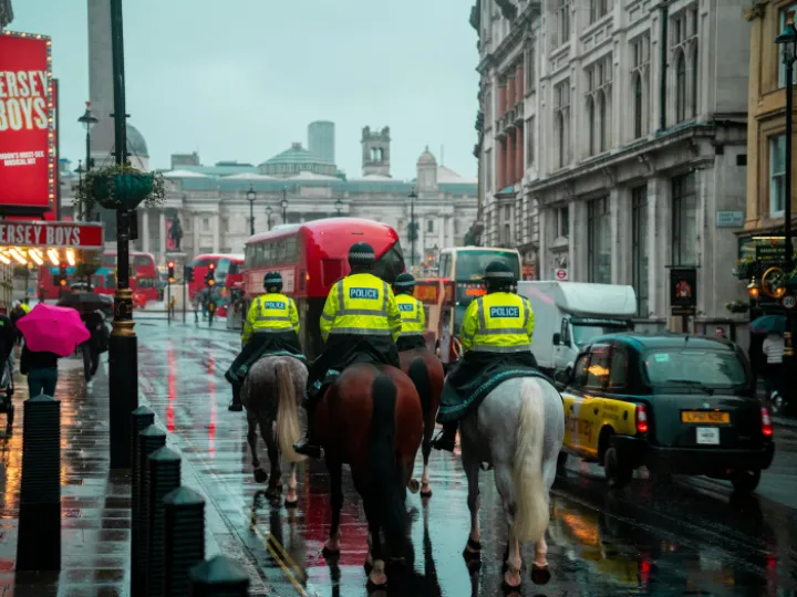 Back View of Police Officers on Horseback on a Busy Street in London, England, UK