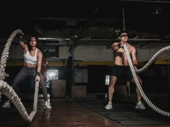 Man And Woman Holding Battle Ropes