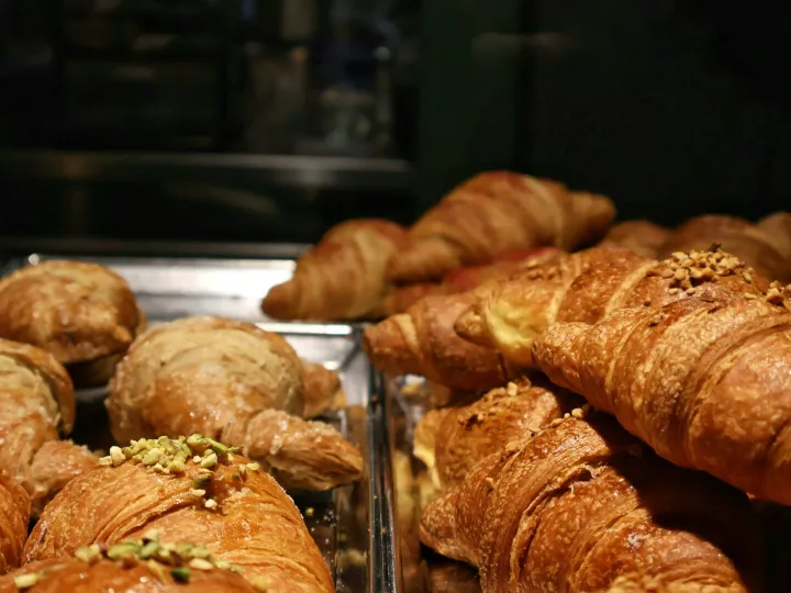 A tempting display of fresh croissants in a Milano bakery, perfect for breakfast.