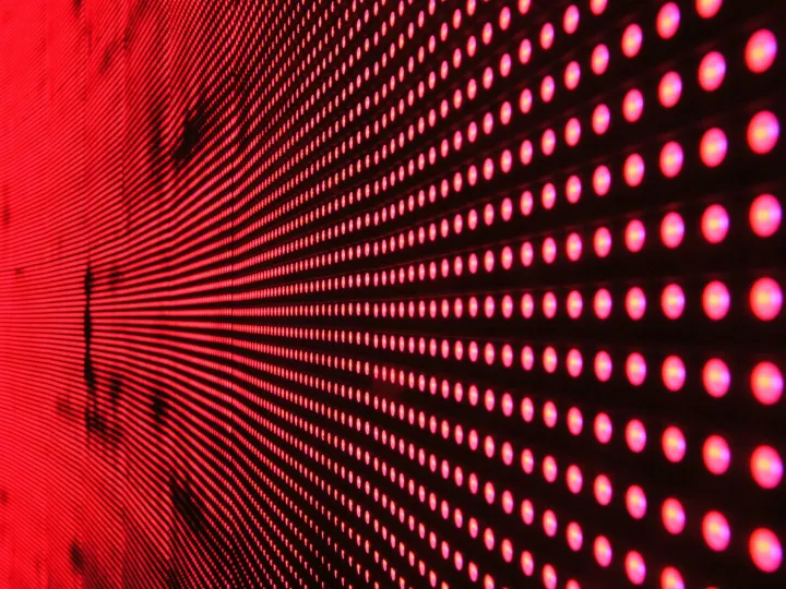 Vibrant abstract pattern of illuminated red LED lights forming a dynamic design.