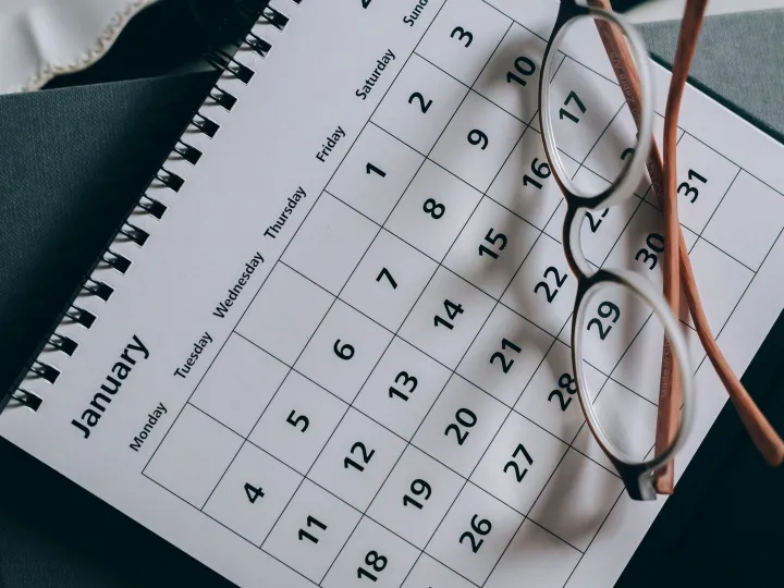 A close-up of a January calendar with eyeglasses