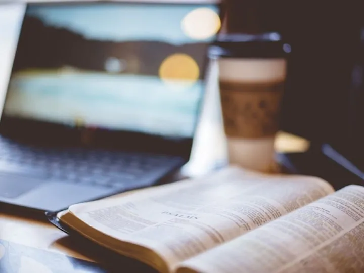 Closeup shot of an open bible with a blurred
