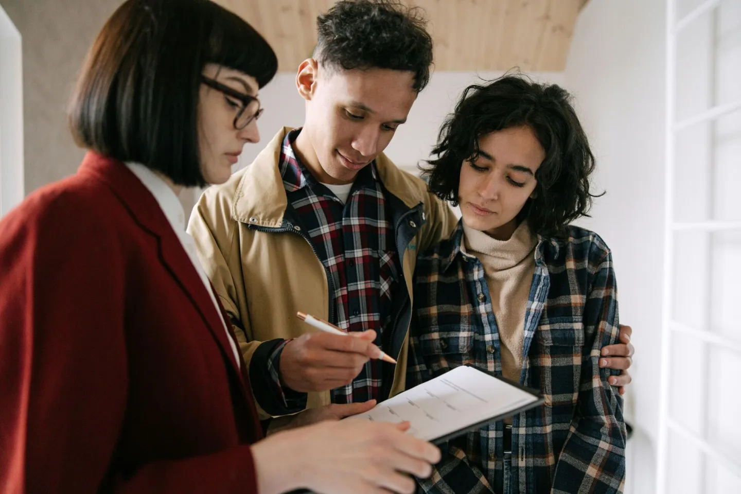 A young couple consults with a real estate agent