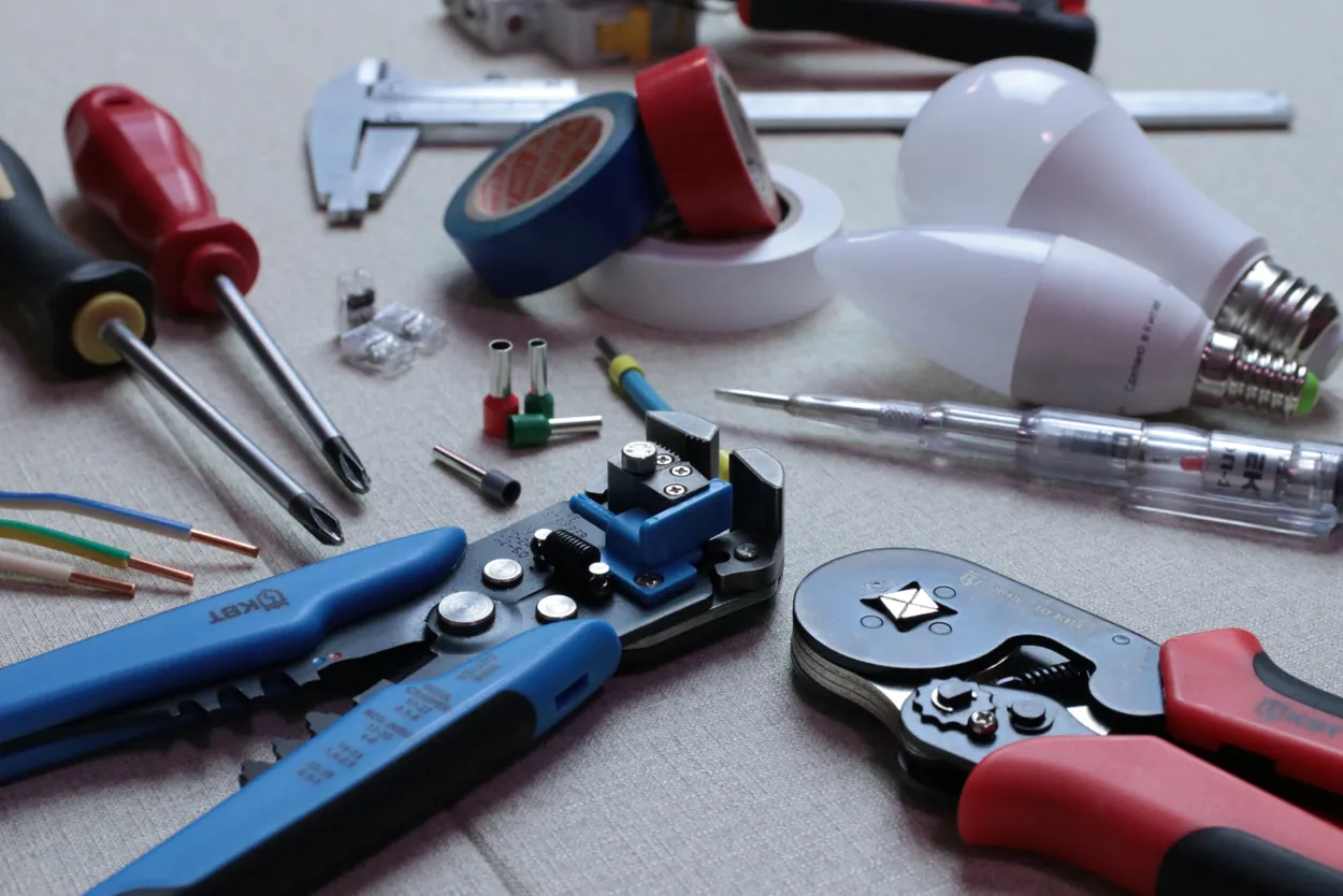 A selection of electrical maintenance tools laid out on a table