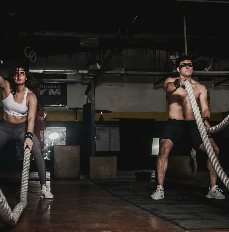 Man And Woman Holding Battle Ropes