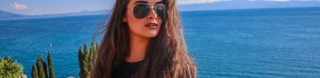 A woman with sunglasses relaxes by the serene