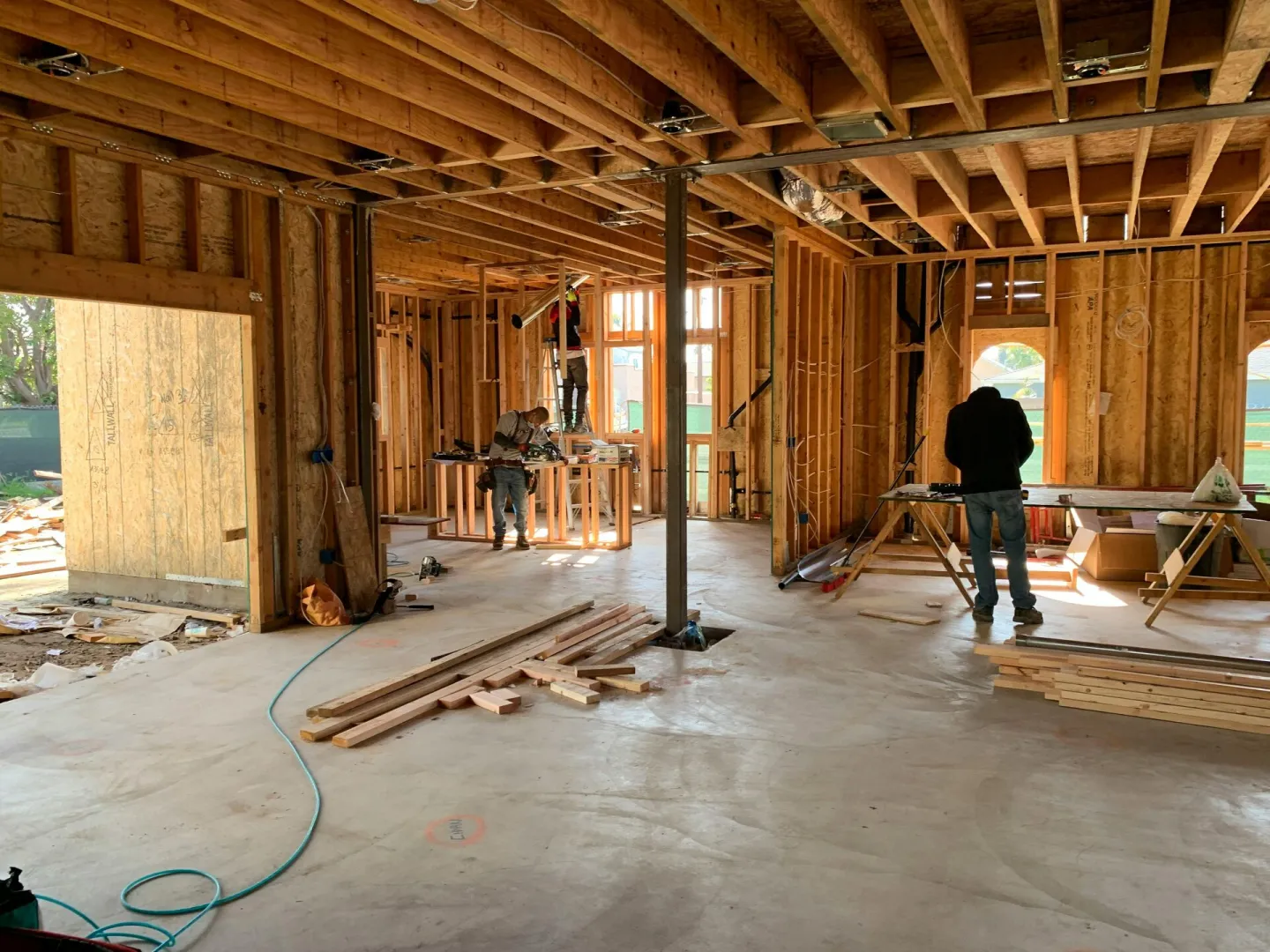 Workers constructing a house framework