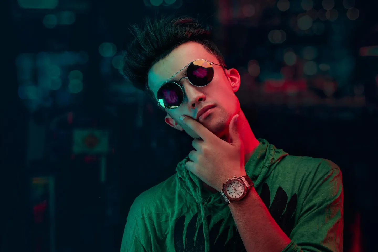 Portrait of a young man in sunglasses and neon