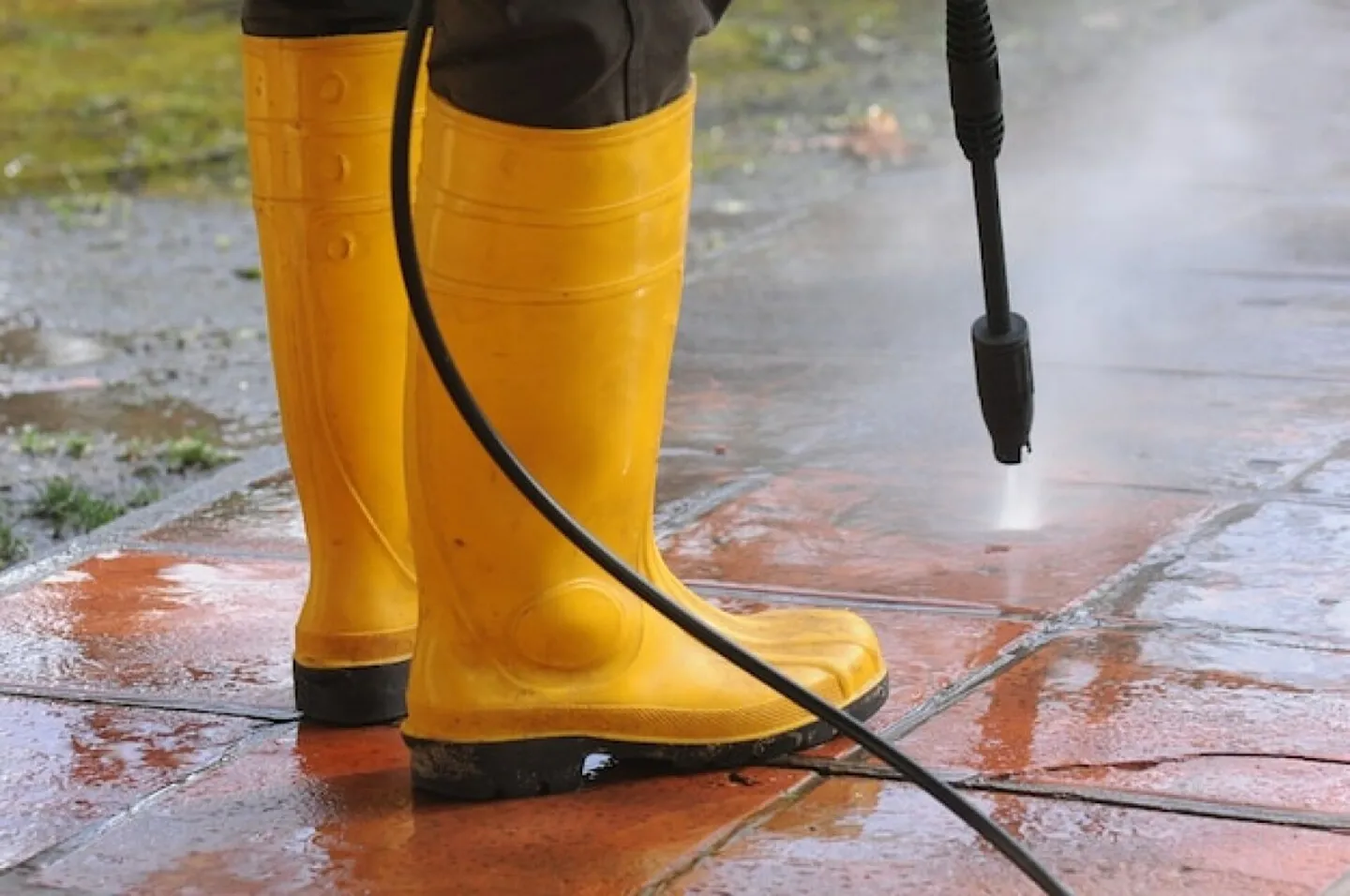 Person wearing yellow rubber boots with