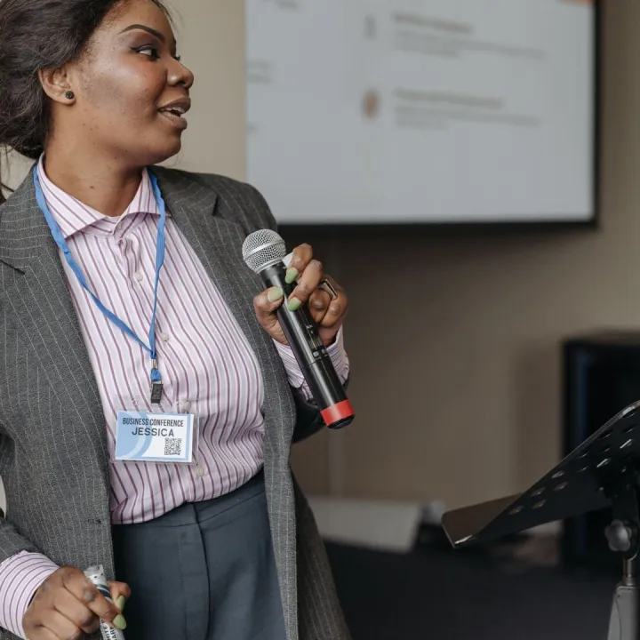 Woman in professional attire presenting at a