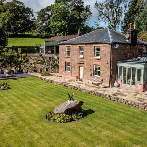 Aerial view of the Farmhouse with its conservatory and lawned garden at Mellor Knowl Farm