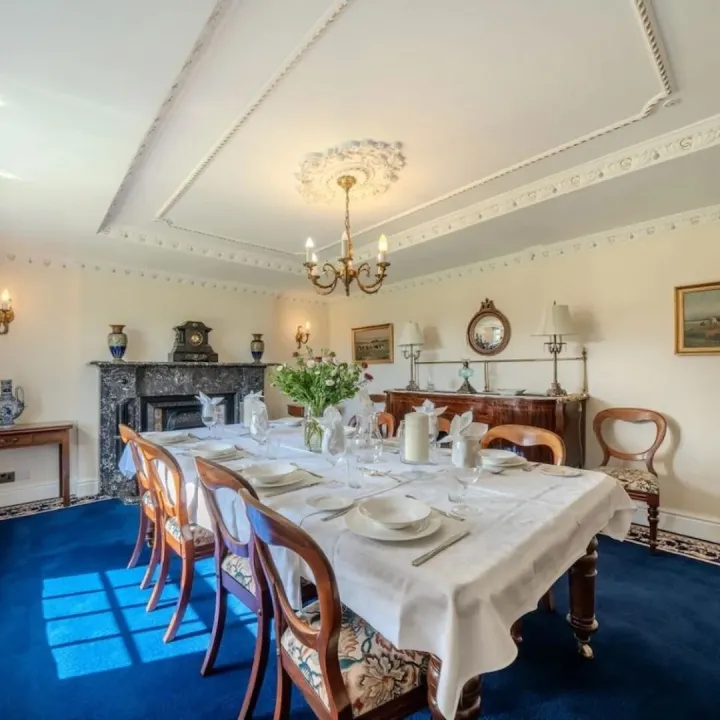 The dining room with a table laid for twelve guests