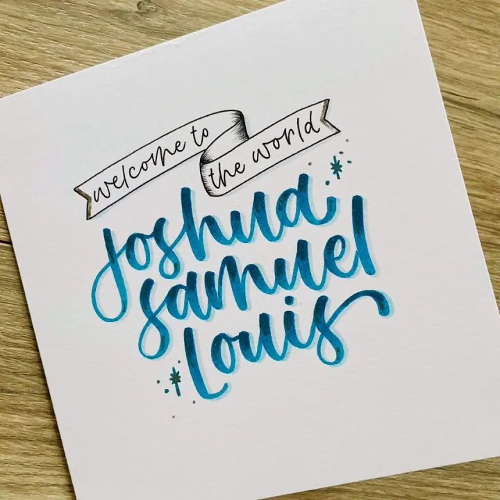 Teal brush lettered name card reading Joshua Samuel on textured paper