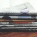 A stack of folded newspapers placed on a wooden