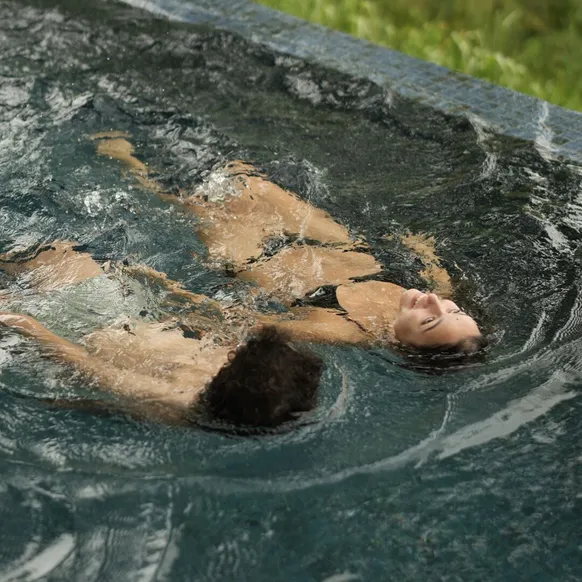 A child swimming underwater in the pool at Peacock Hill Sigiriya