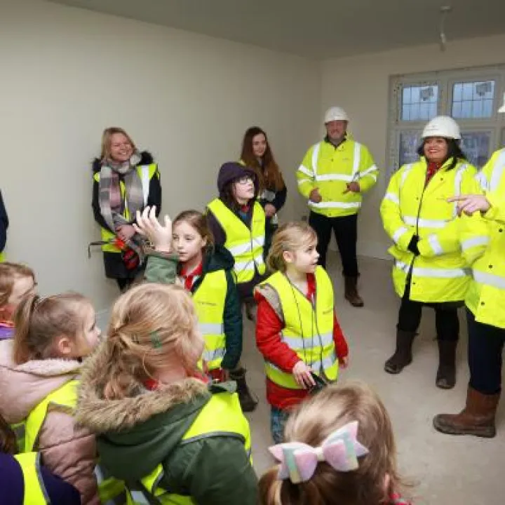 Area Sales Manager Matt Gould showing Children from Tattenhall Rainbows around the construction site at Redrow's Meadow Brook development. credit: leeboswellphotography.com