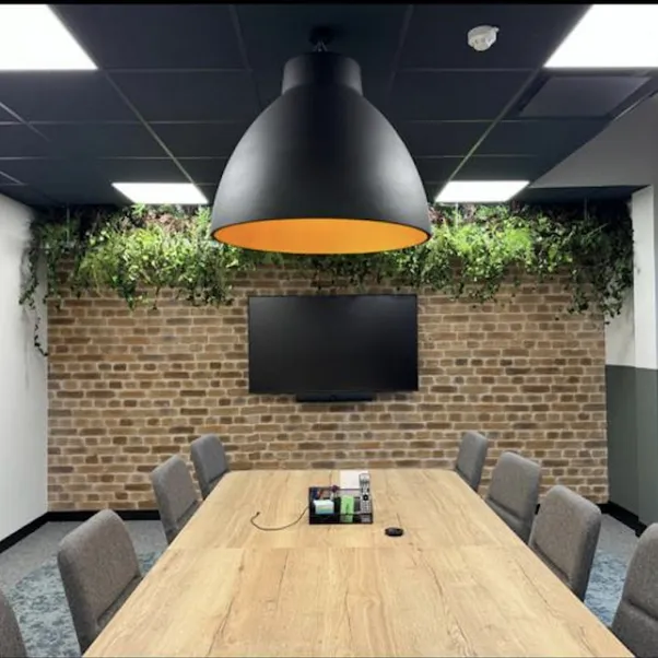 A Manchester office meeting room with a large overhead lamp