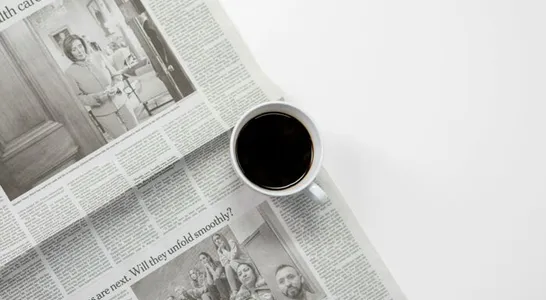White Ceramic Mug On Top of a Newspaper