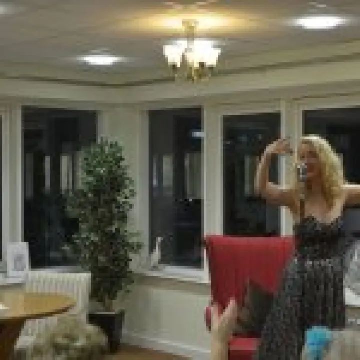 Bexi Owen singing to dementia residents limewood