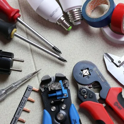 A selection of electrician's tools arranged on a table