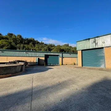Industrial units with green roofs and brick walls