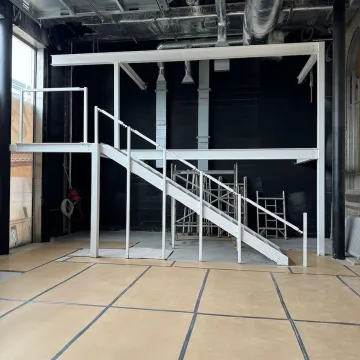Warehouse construction featuring metal staircase and steel framework