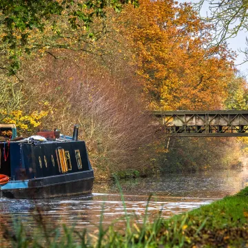 Narrowboat on a canal in autumn