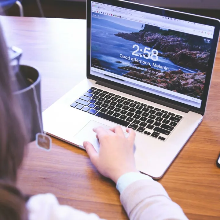 Person using a laptop with a browser open, ideal for remote work themes.