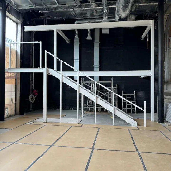Warehouse construction featuring metal staircase and steel framework