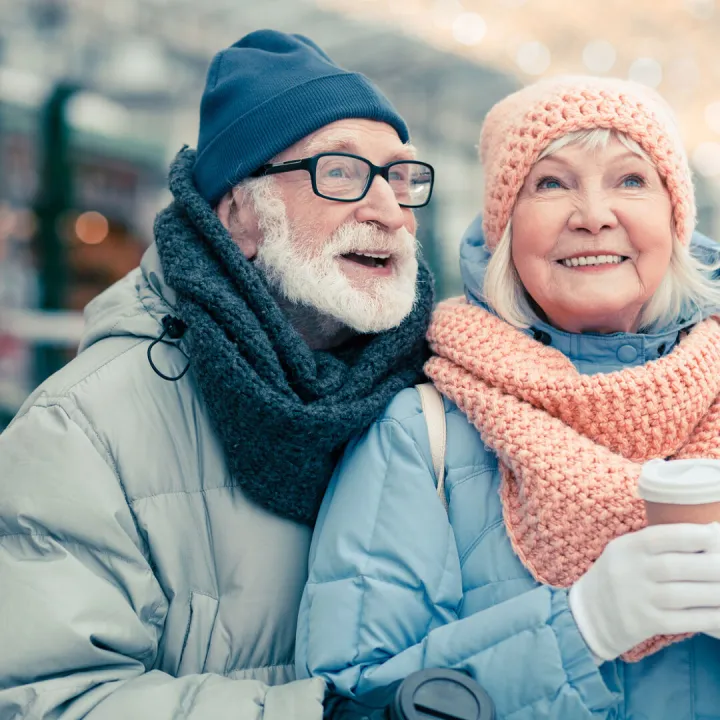 Elderly Couple Wrapped Up Warm For Winter
