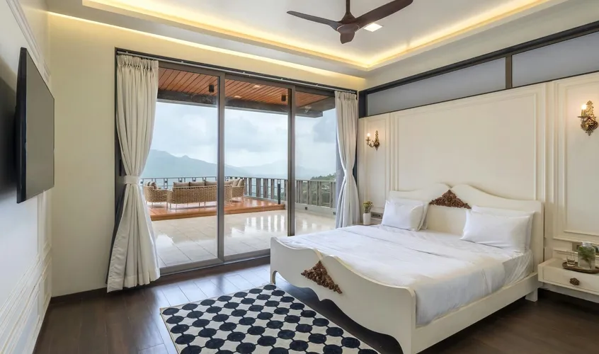A spacious modern bedroom with a double bed and soft natural light