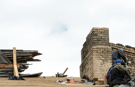 Repair of a wooden roof and an old brick chimney pipe Worker