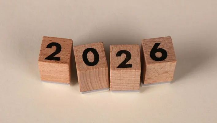 Wooden cubes forming the year 2026 on a neutral