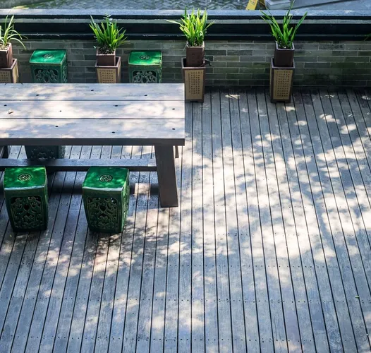 Terrace with a wooden table and plants